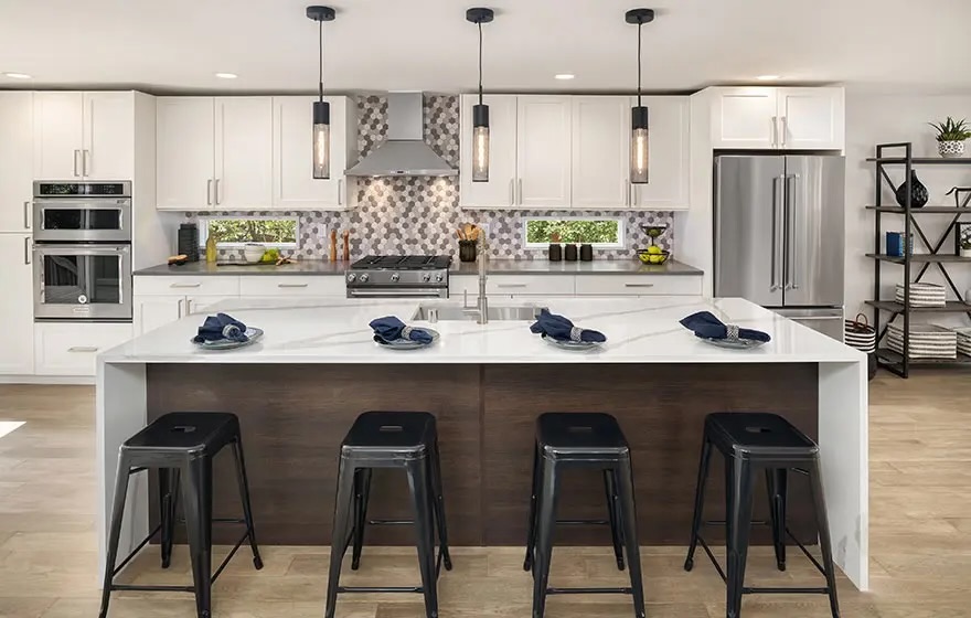 Mixed material kitchen with mosaic backsplash and waterfall island